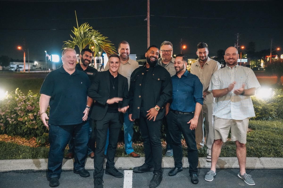 Lion's Den members gathered together after dark
